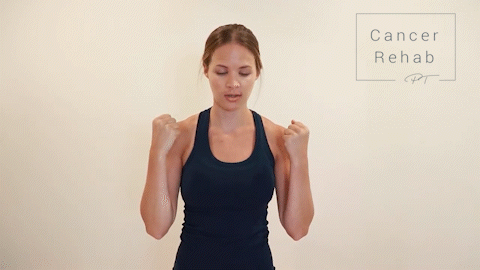 Female Physical therapist navy tank top doing bicep curls for arm lymphedema