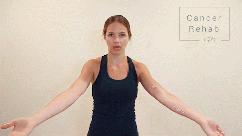 Female Physical therapist navy tank top doing wrist rotation for arm lymphedema