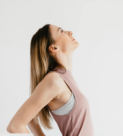 woman in pink shirt looking up