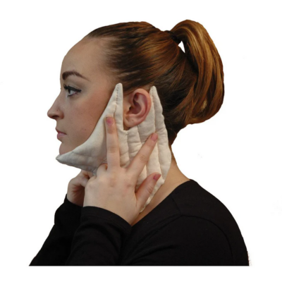 woman facing to the side, holding a light tan padded neck garment to her jaw and below the ears
