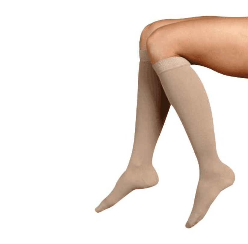 Woman wearing compression socks for leg lymphedema - Juzo Soft Knee-High Stocking