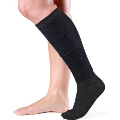 black velcro wrap on a lower leg with black stocking on under