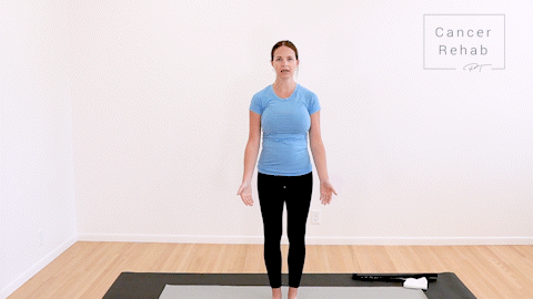 animated clip of physical therapist standing on yoga mat, showing how to do a bicep curl with both arms