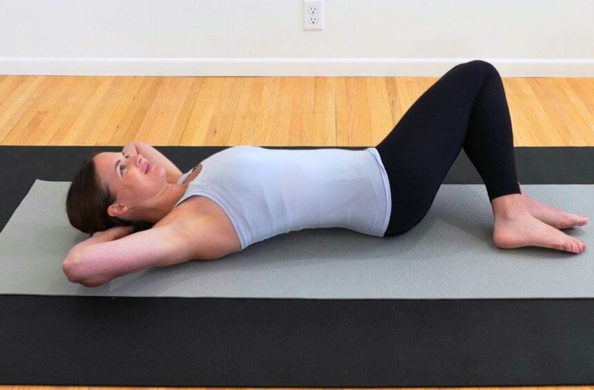 physical therapist lying on a mat on the floor demonstrating breast cancer exercises after surgery