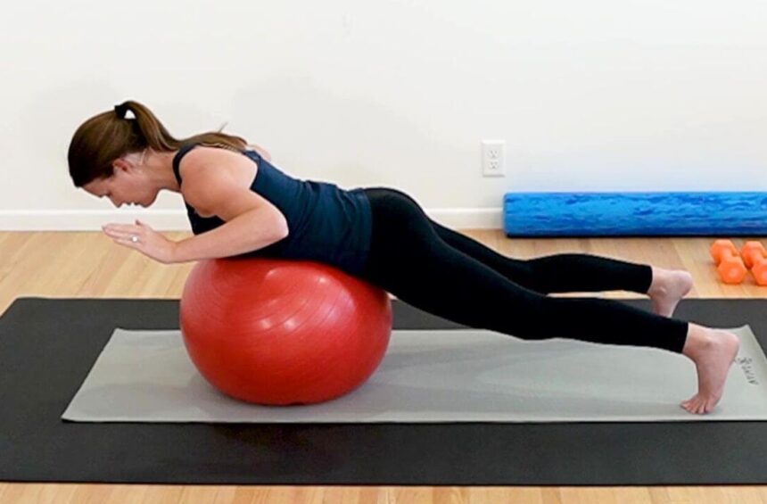 breast cancer recovery exercises shown by a physical therapist lying on a yoga ball