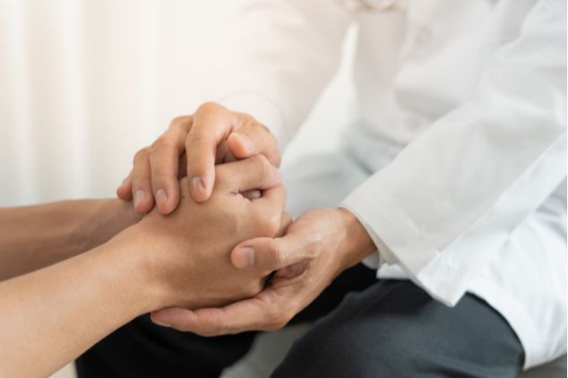 Image of healthcare provider supporting cancer patient emotionally.