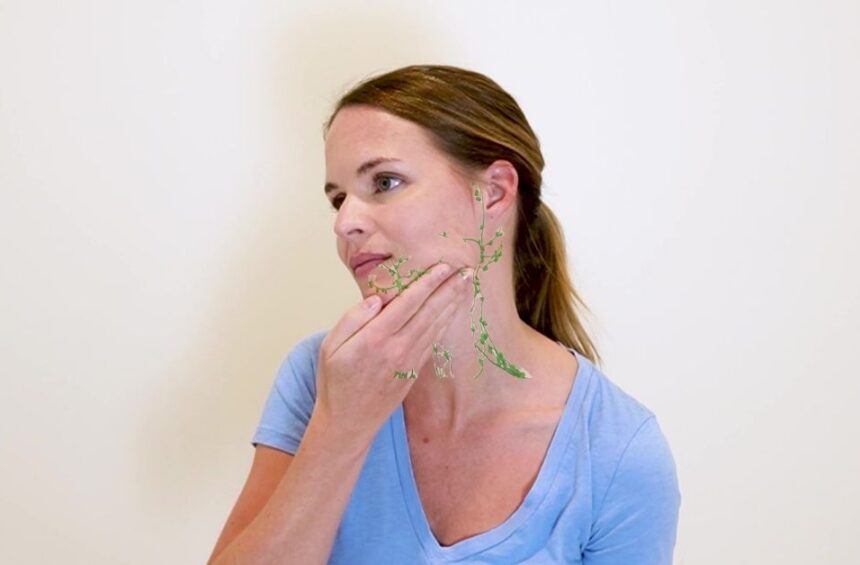 Woman doing lymphatic drainage massage to improve poor lymphatic drainage in the face.