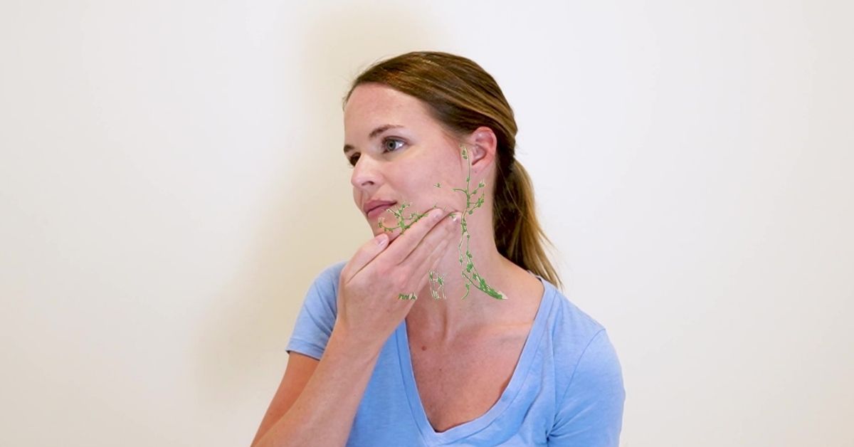 Woman doing lymphatic drainage massage to improve poor lymphatic drainage in the face.