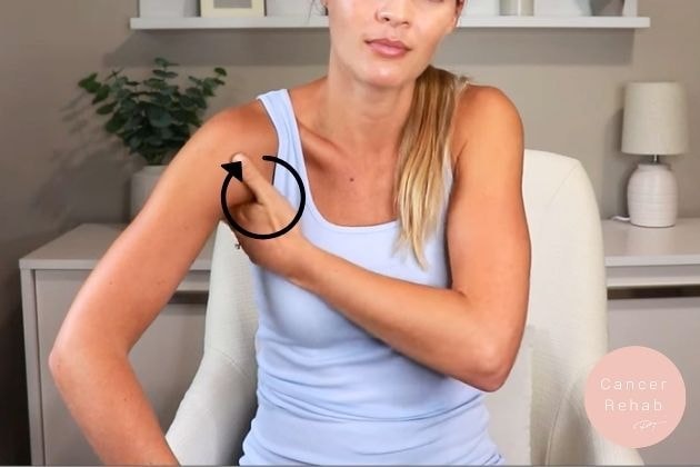 A woman using her hand to massage the lymph nodes in her armpmit.