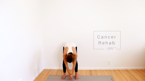 A certified lymphedema therapist on her hands and knees, arching her back and then rounding her spine in a cat-cow position.