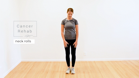 A certified lymphedema therapist standing tall and gently rolling her neck from side to side.