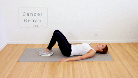 A woman lying on her back with her feet on the ground. She is twisting her knees to the side.