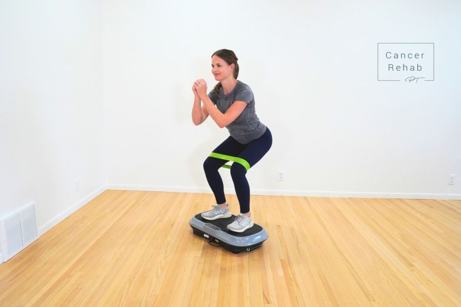Physical therapist doing exercise on a vibration plate.